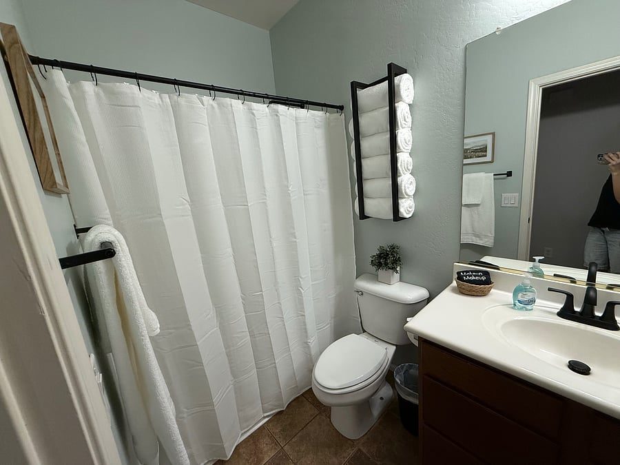 Full bathroom with shower, vanity and towels in the furnished Maricopa, Arizona home