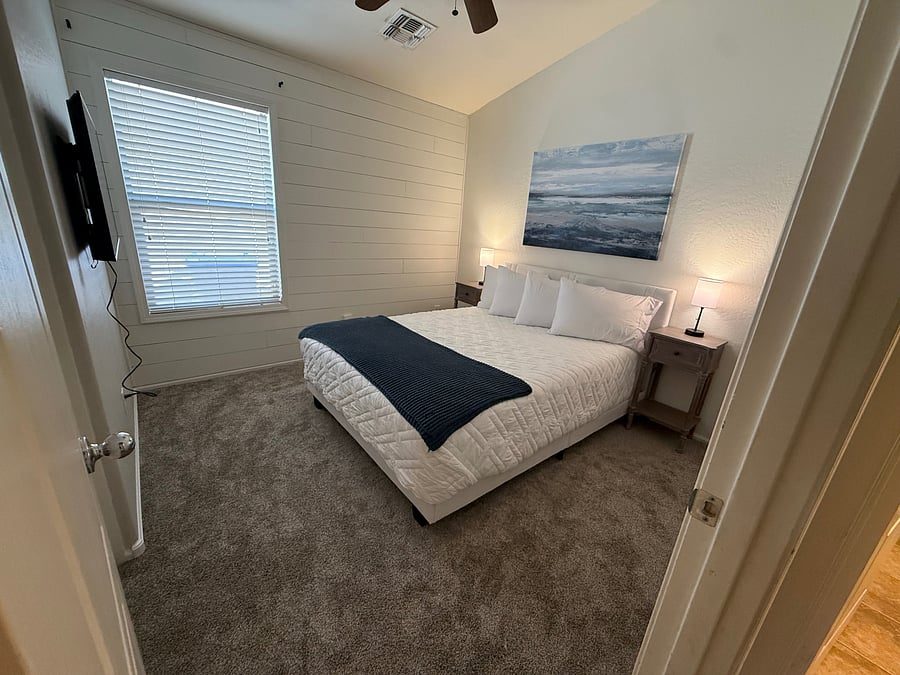 Third furnished bedroom with ceiling fan and window blinds in the Maricopa rental home